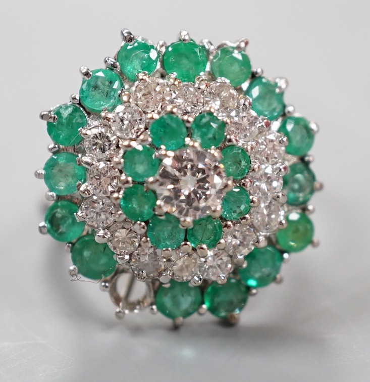 A modern 18ct white gold emerald and diamond cluster set dress ring, (emerald missing), size J, gross weight 6.9 grams.